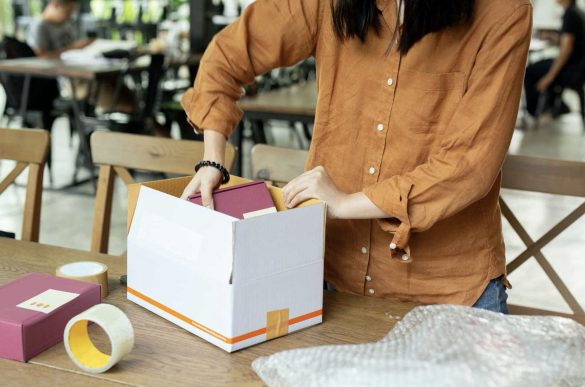 eCommerce merchant packing a product using their own packaging